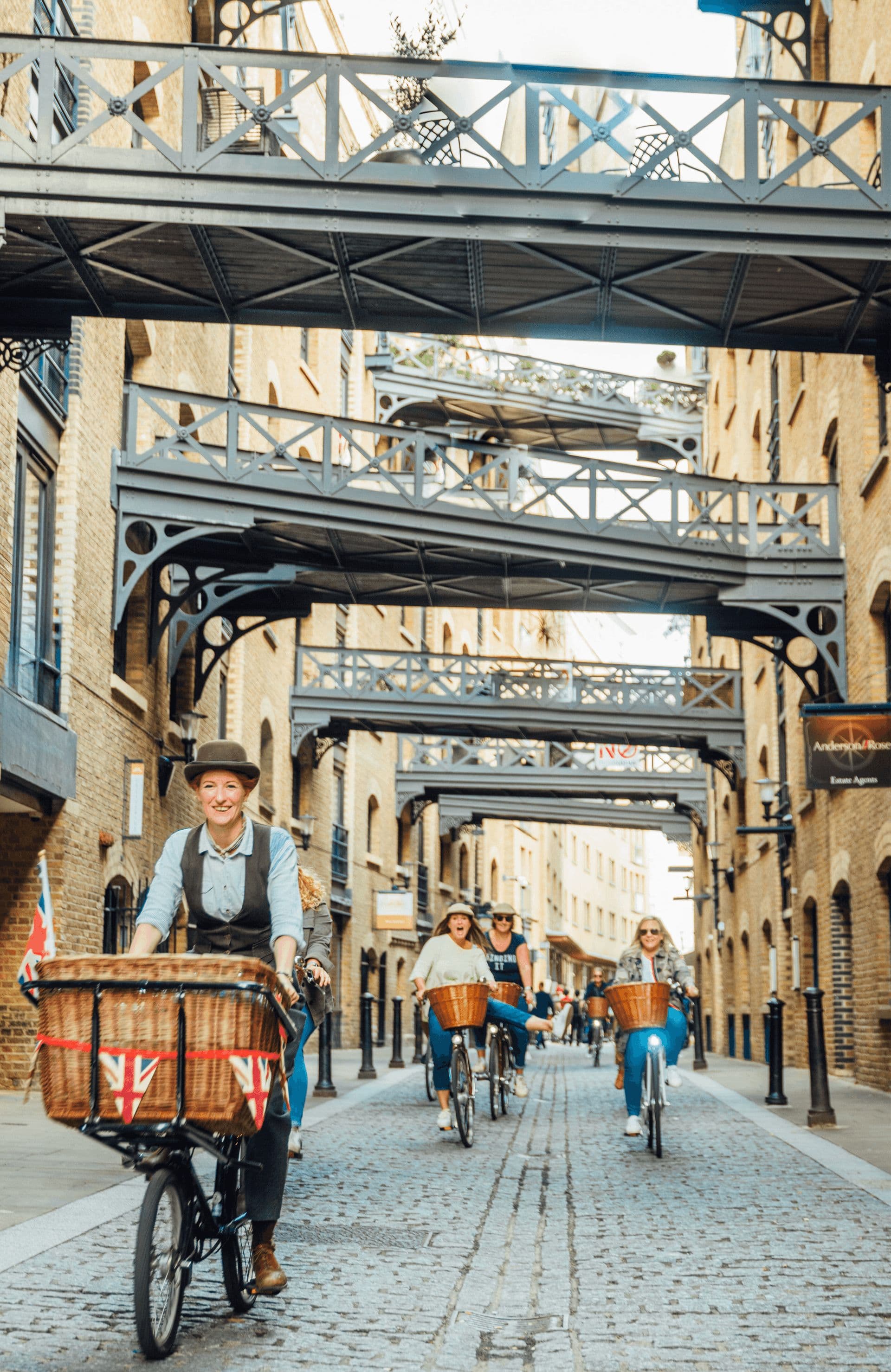 Vintage cyclists riding through Shad Thames in London