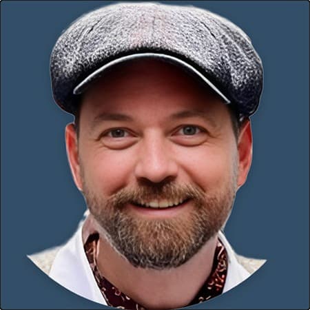 Jack Harris the founder of Tally Ho wearing a tweed cap and smiling