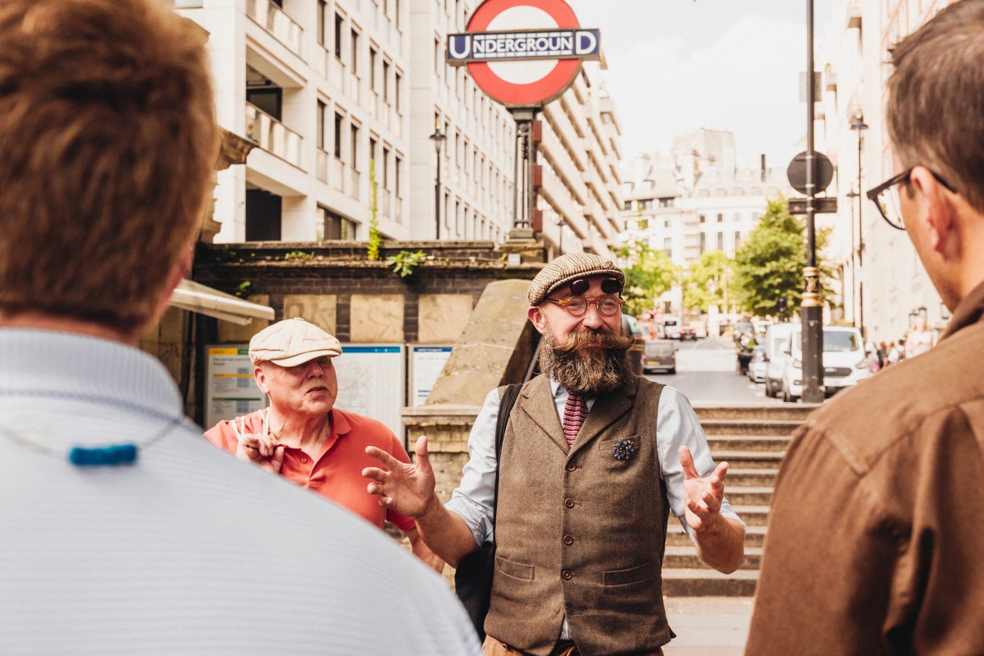 A Tally Ho guide meets a group outside of the London Underground