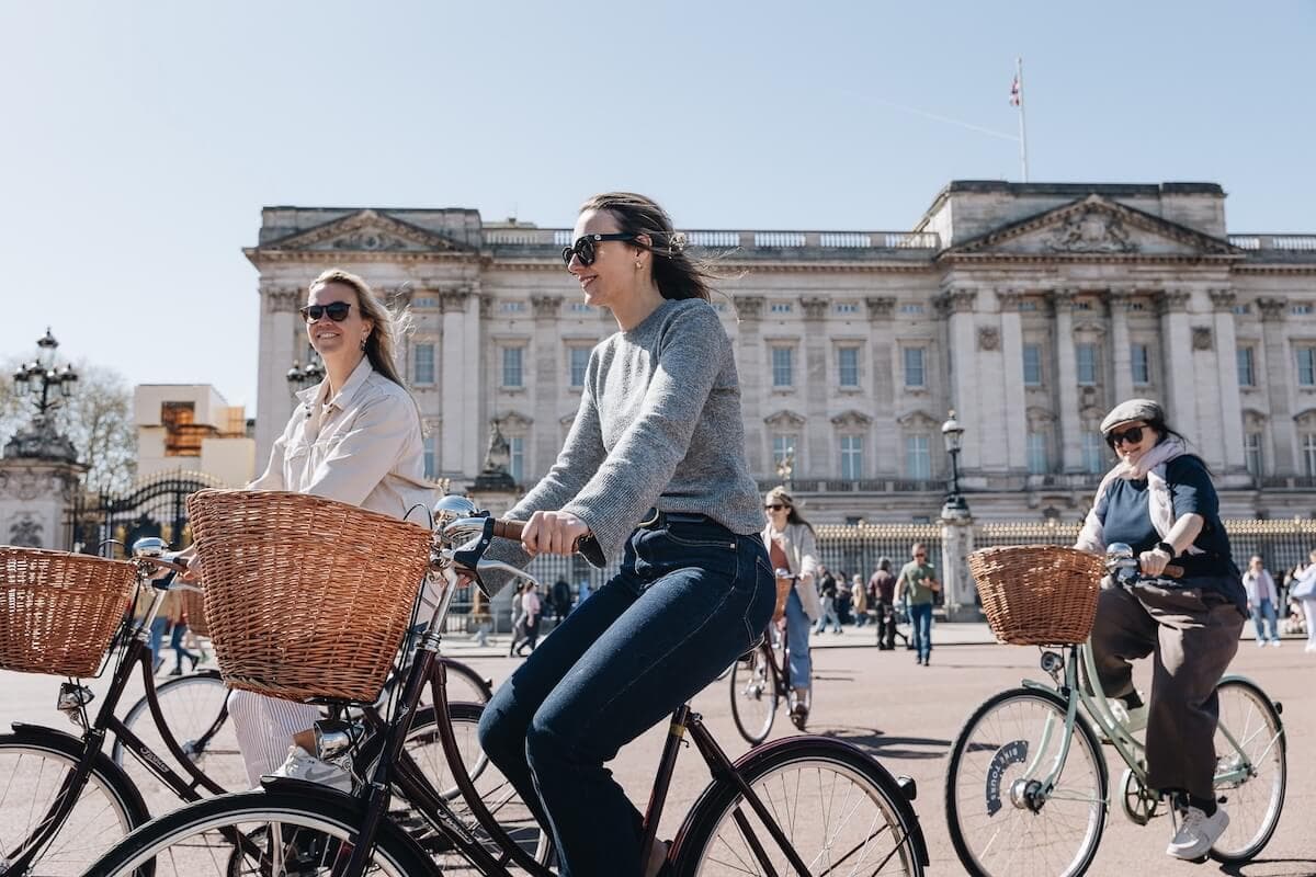 Friends laughing on a guided London bike tour with vintage Pashley bicycles