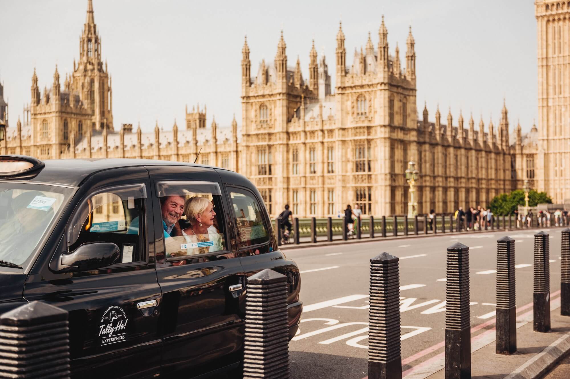 Tally Ho guests in a black cab passing the Houses of Parliament