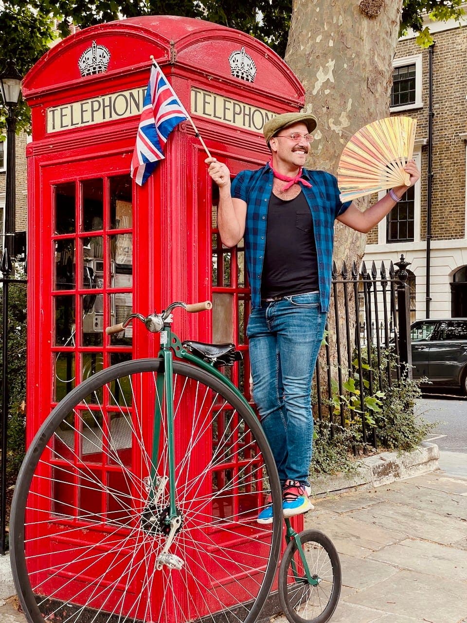 A Tally Ho guest poses for a photograph with a penny farthing and red telephone box