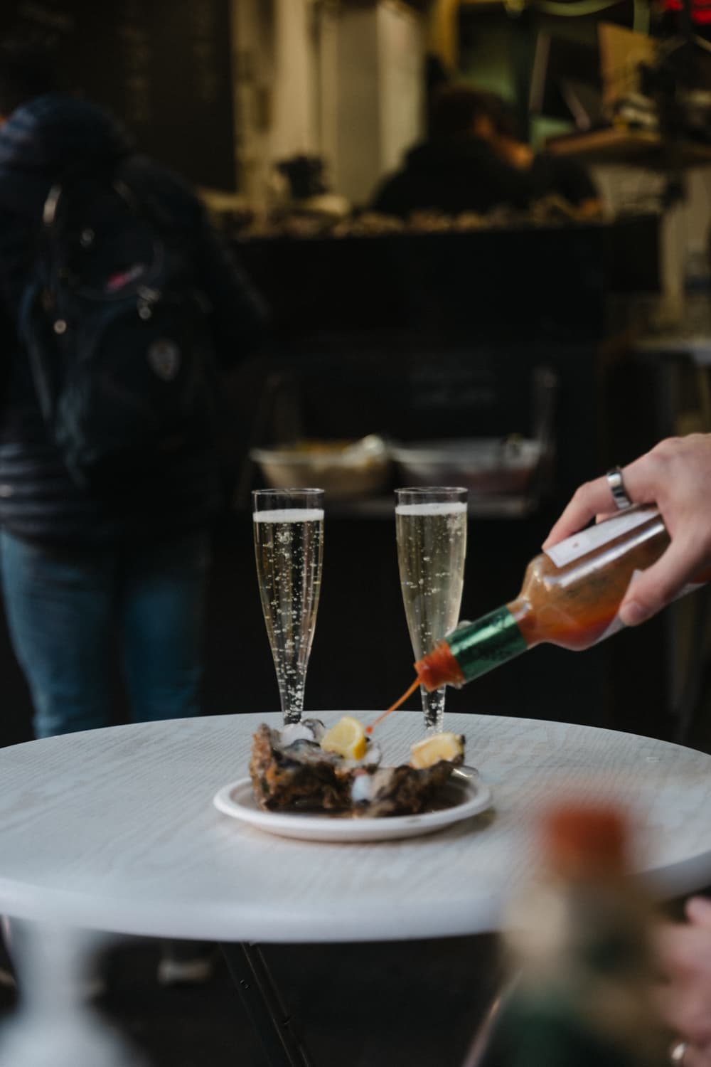Champagne and oysters at a London market on a private Tally Ho food experience