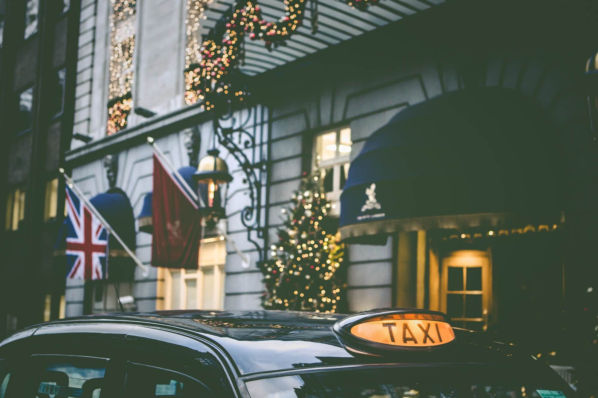 Tally Ho black cab collecting guests from a London hotel