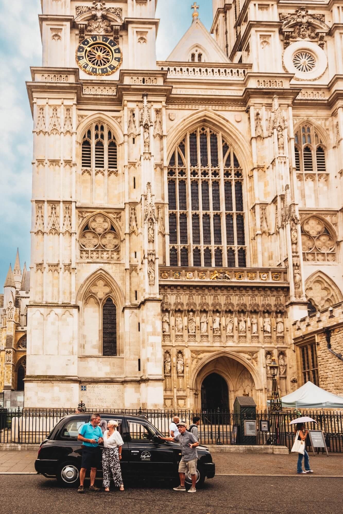 Tally Ho black cab and guests with their driver-guide outside Westminster Abbey